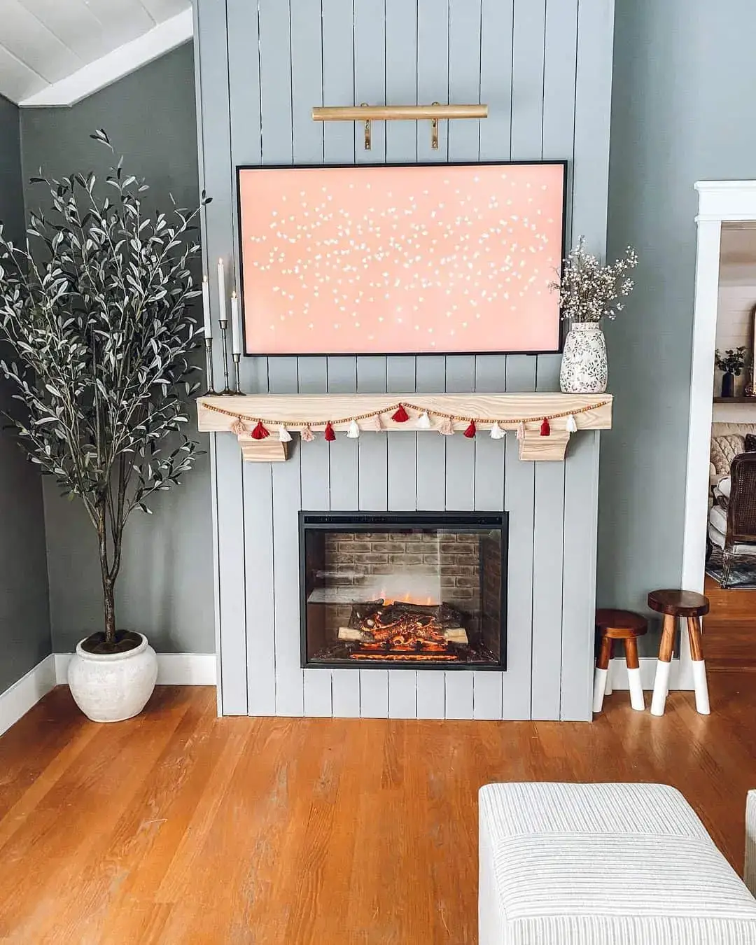 Shiplap Fireplace Wall Frames a TV Display with Festive Garland