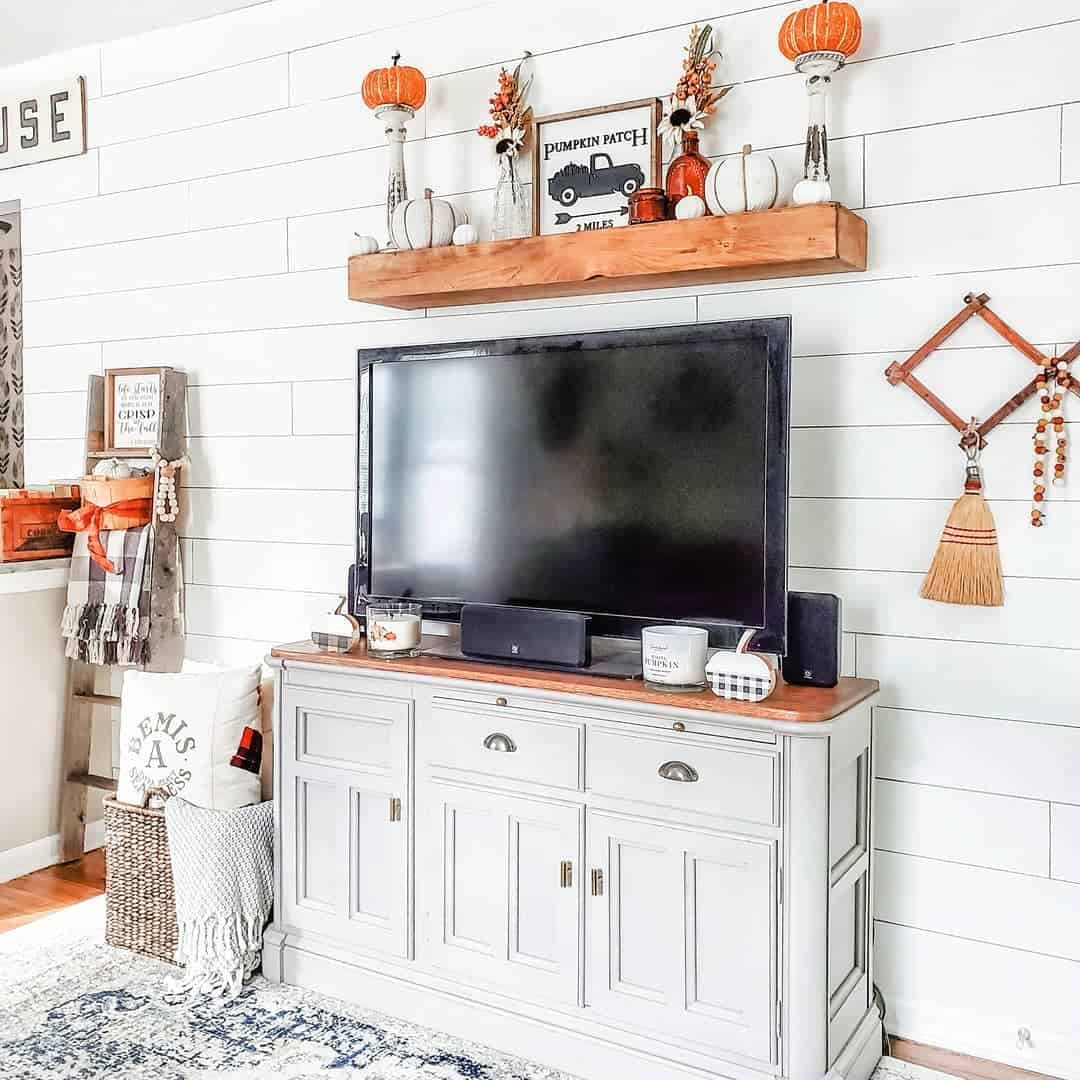 Wooden Shelf Displays Seasonal Decor Above TV