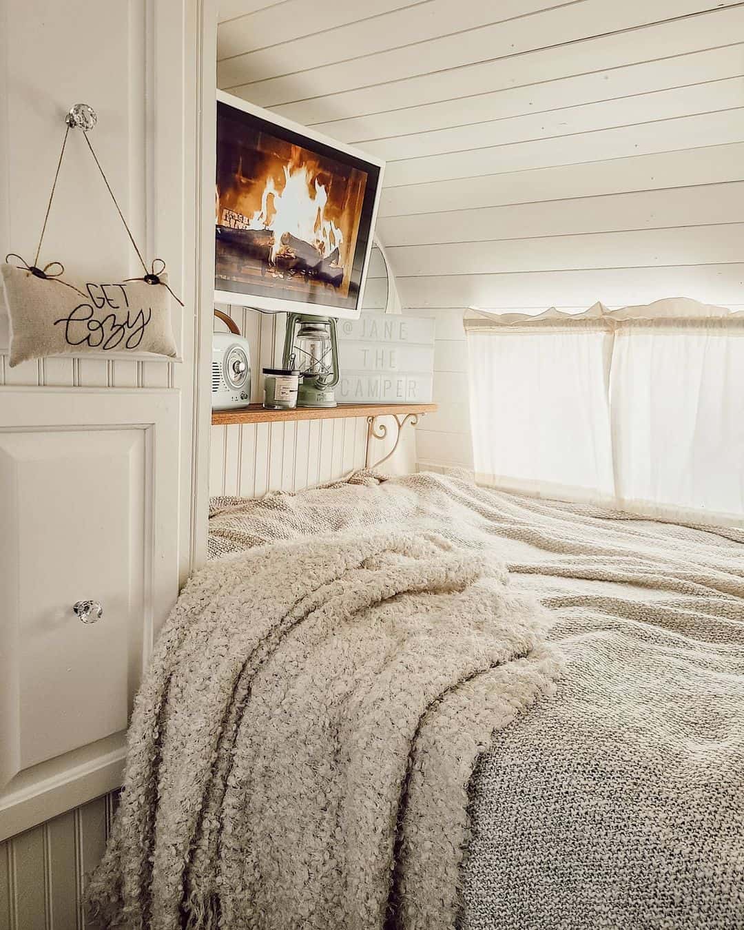 Shiplap Wall Frames a Cozy Bed With a Hidden TV
