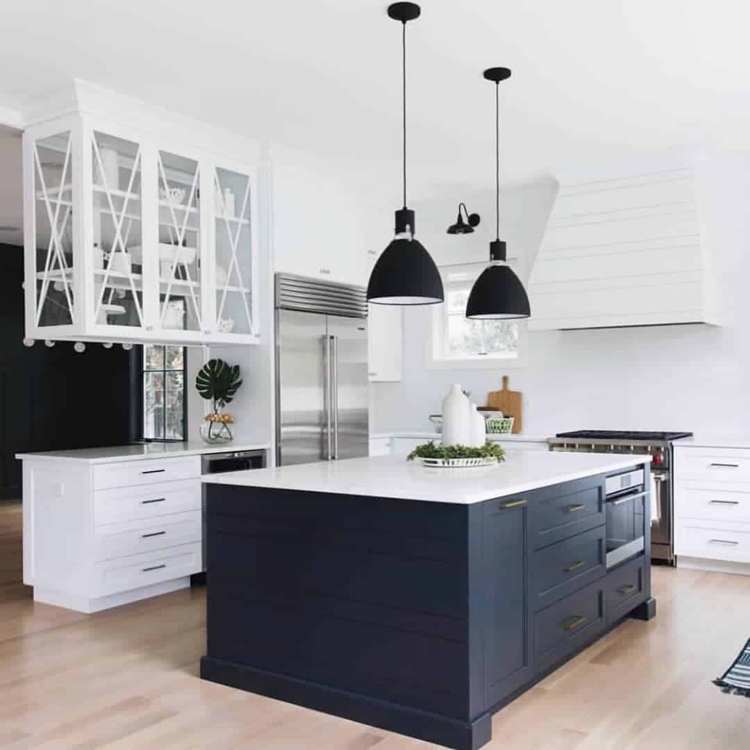 Deep Navy Island Cabinets with Subtle Gold Hardware