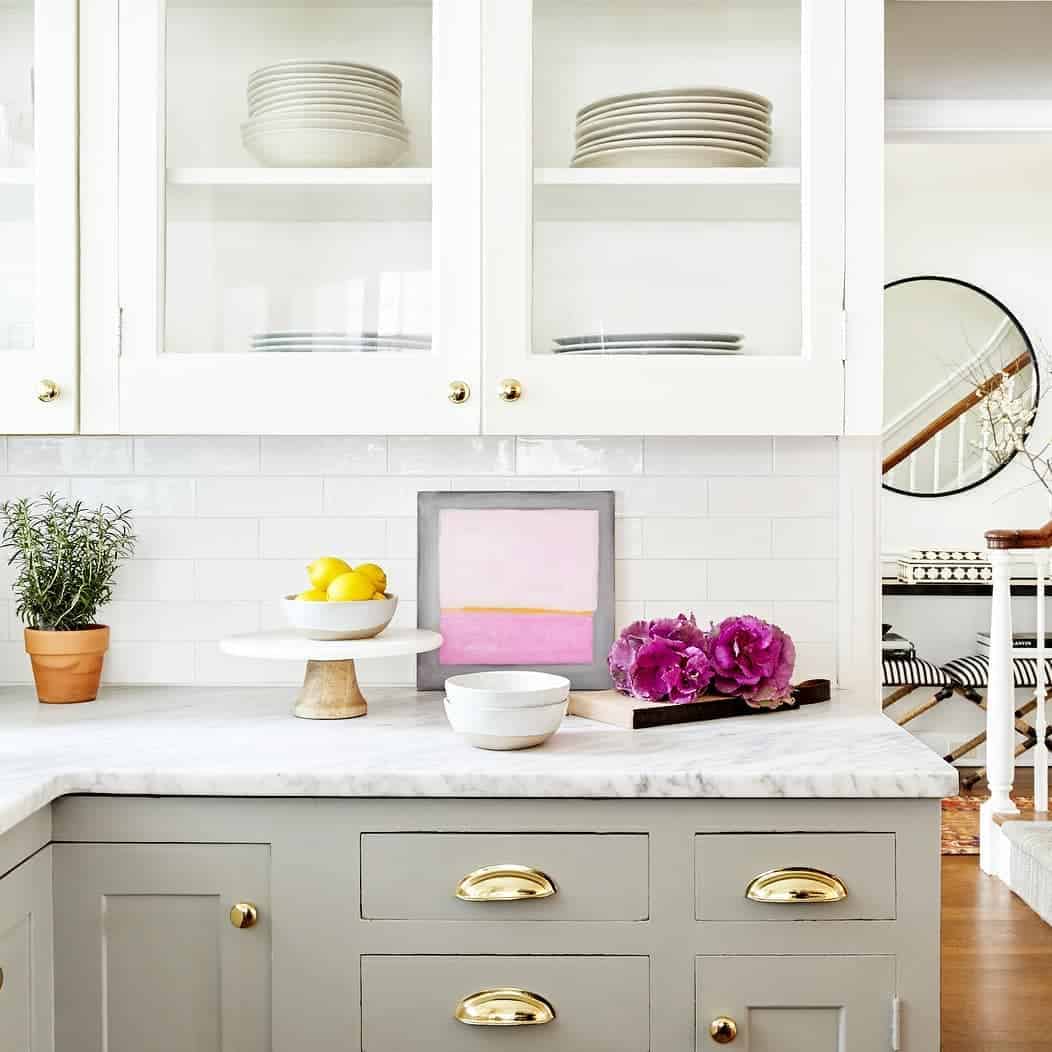 Light Gray Base Cabinets with Arching Brass Pulls