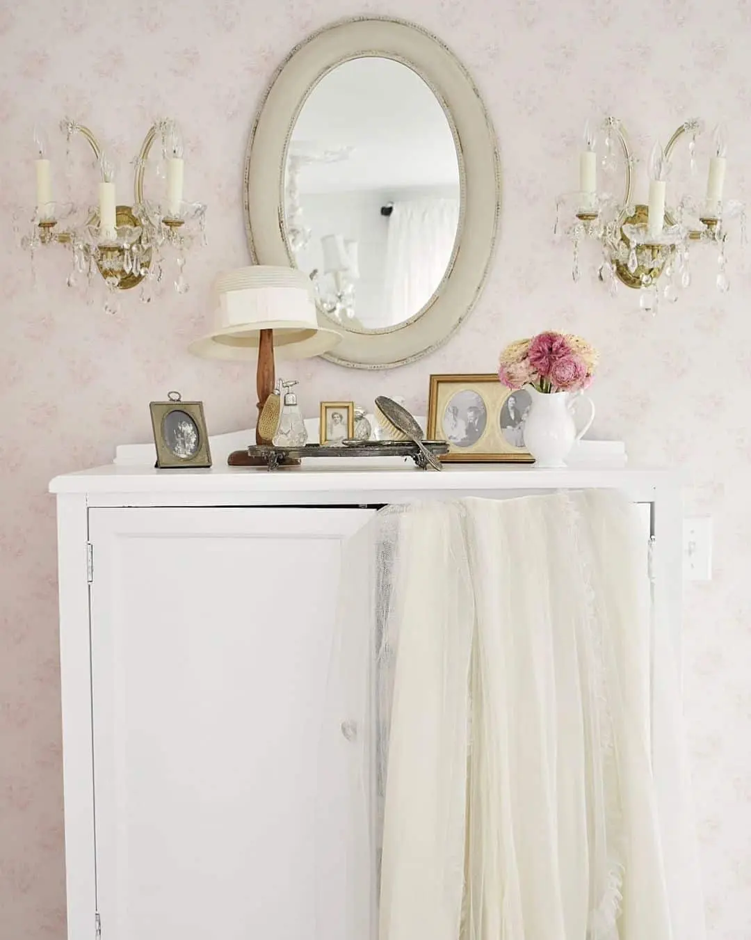 Oval Mirror and Sconces Frame a Romantic Vanity Display