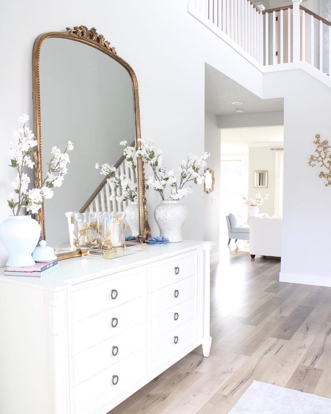 Ornate Gold Mirror Frames a Staircase View