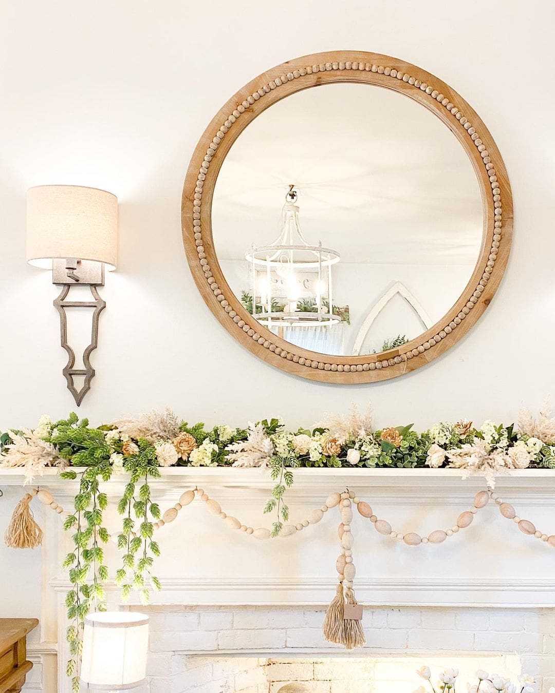 Round Wood Bead Mirror Frames a Layered Mantel Garland