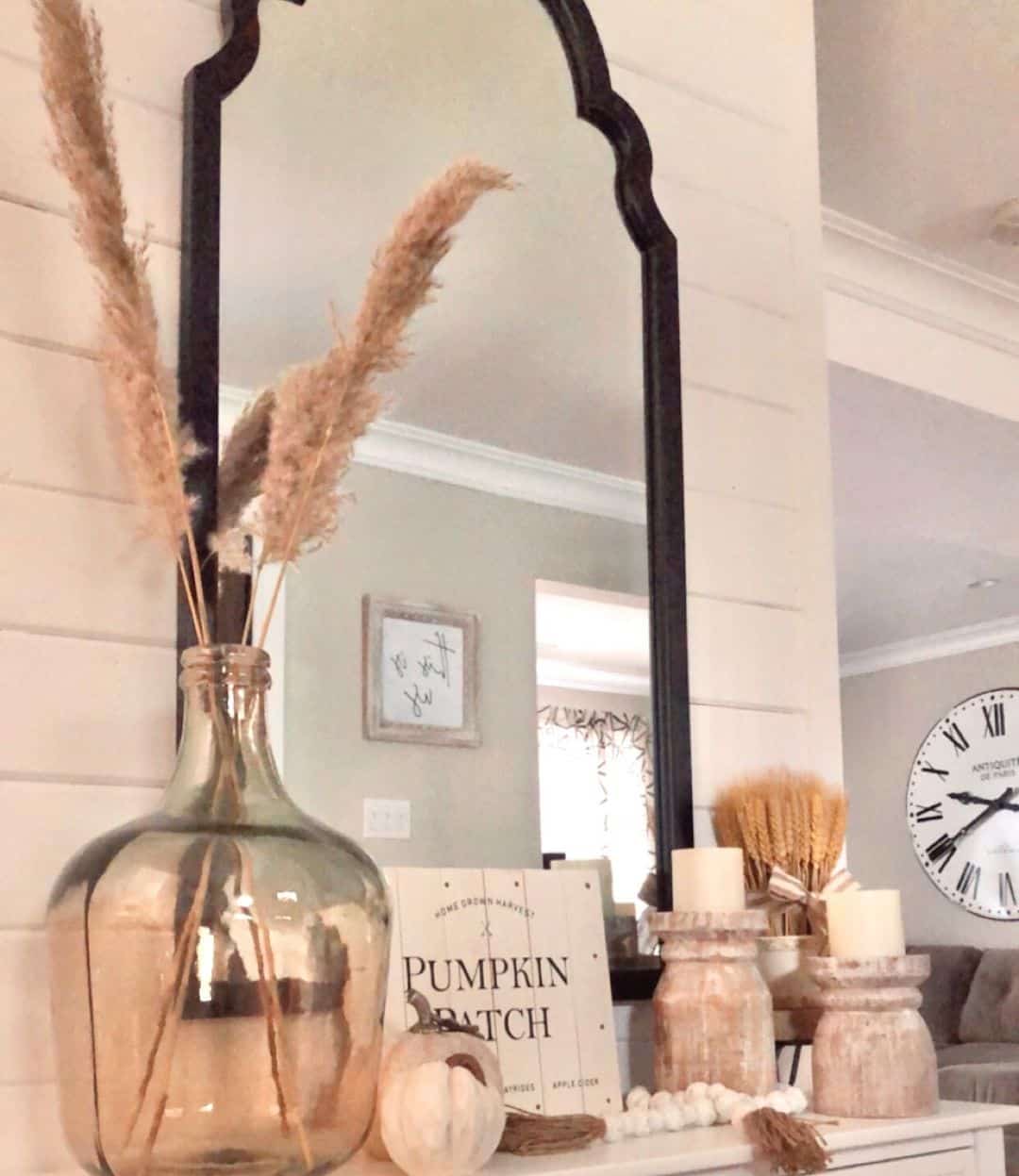 Arched Mirror Frames a Whimsical Mantel Display with Pampas Grass