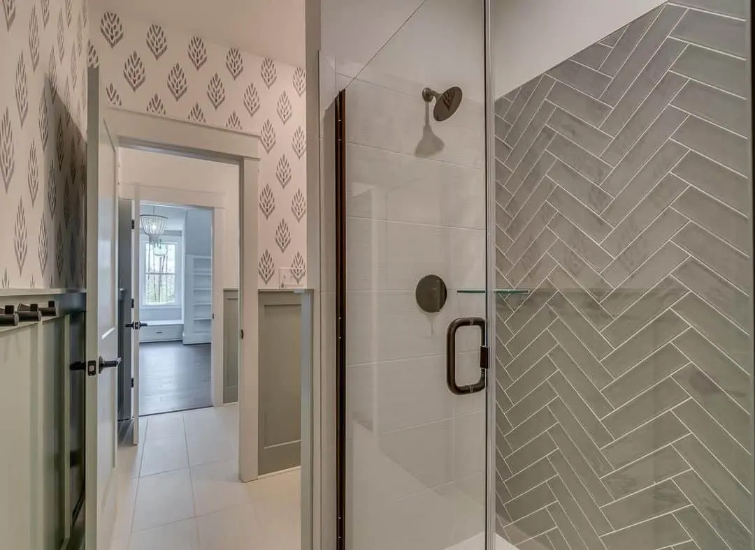 Grey Herringbone Tile Creates a Dramatic Shower Enclosure