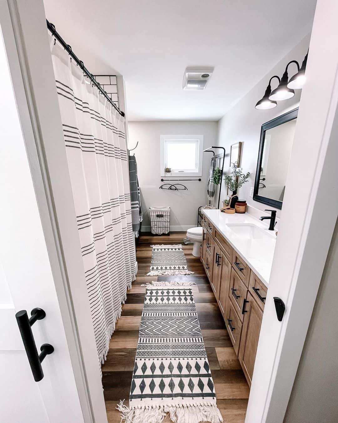 Layered geometric runners define the bathroom path