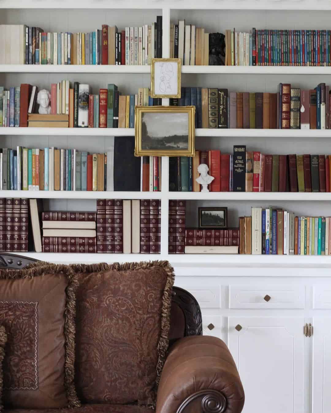 Framed Artwork Adds Personal Style Between Book Stacks