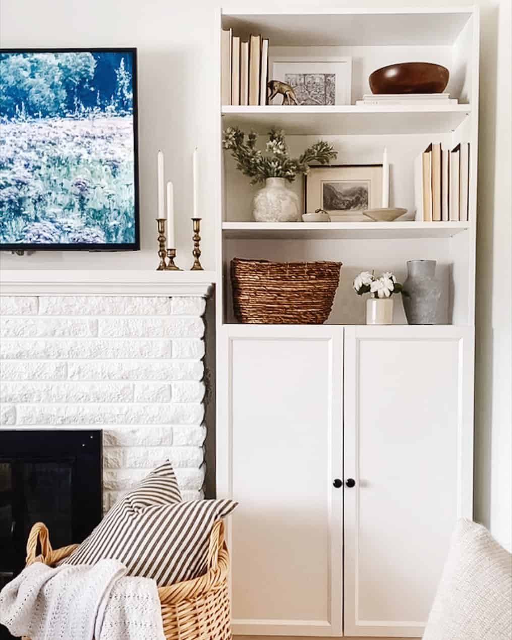 Layered artwork and vases create visual depth on shelves