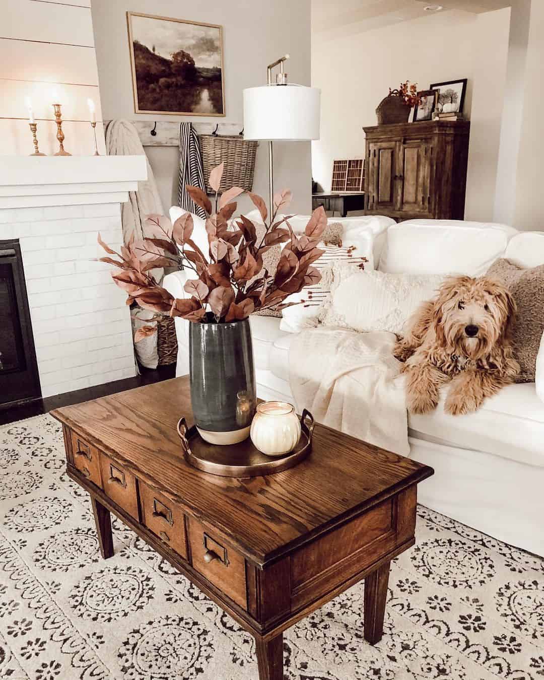 Dark vase with faux branches anchors the coffee table display