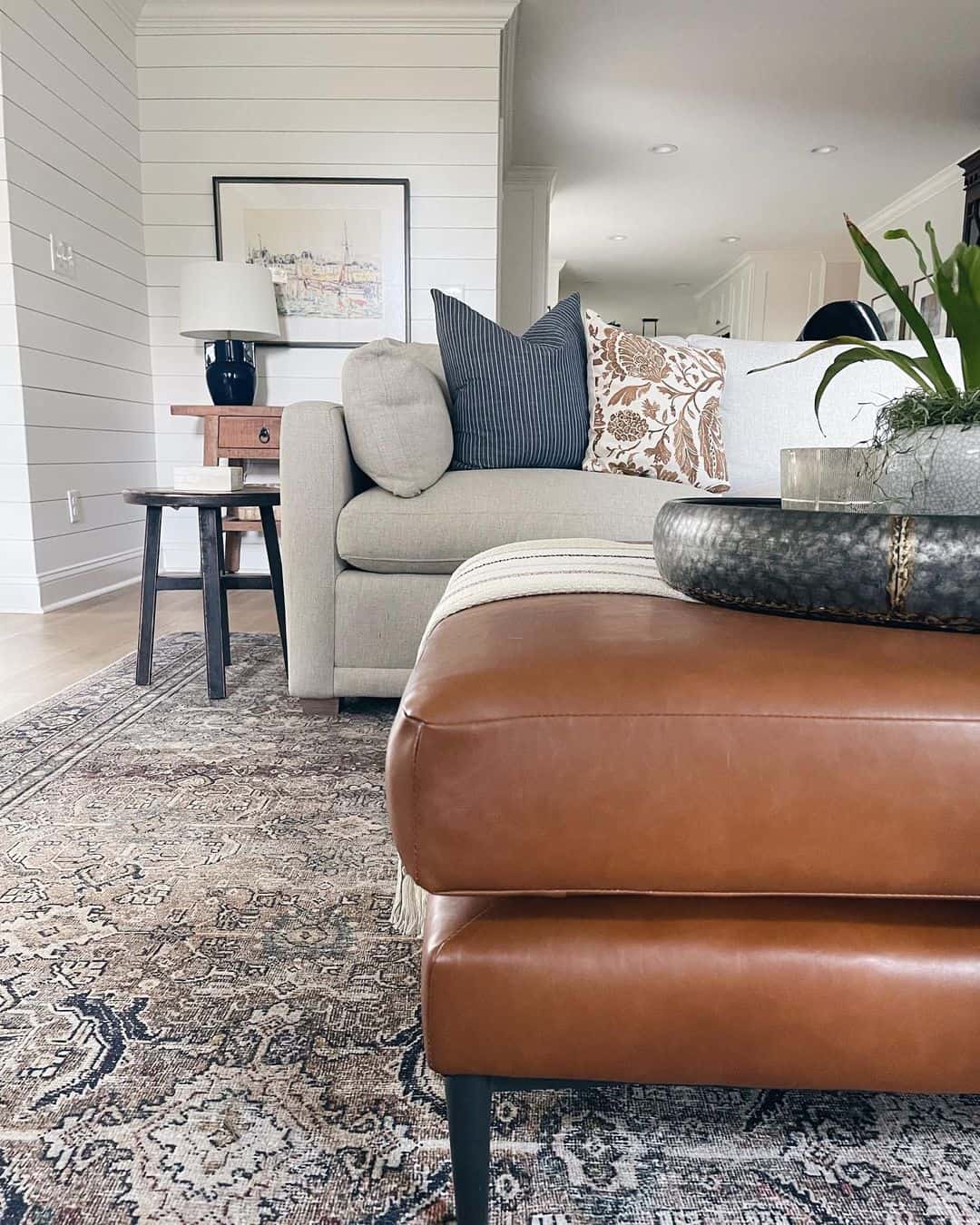 Brown Leather Ottoman with Subtle Black Legs for Modern Contrast