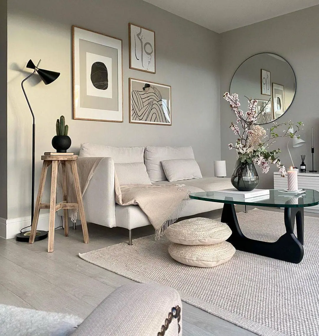 Round Coffee Table With Sculptural Base Holds Floral Arrangement