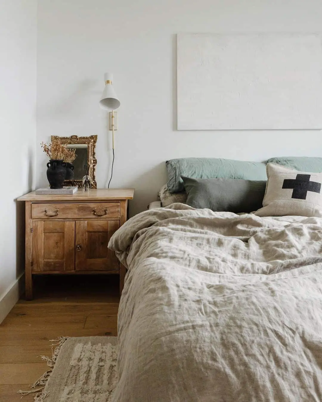 Ornate Gold Mirror Above a Rustic Nightstand