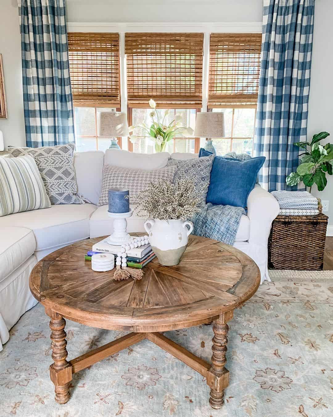 Round Rustic Wood Table Anchors a Cozy Blue and White Living Area