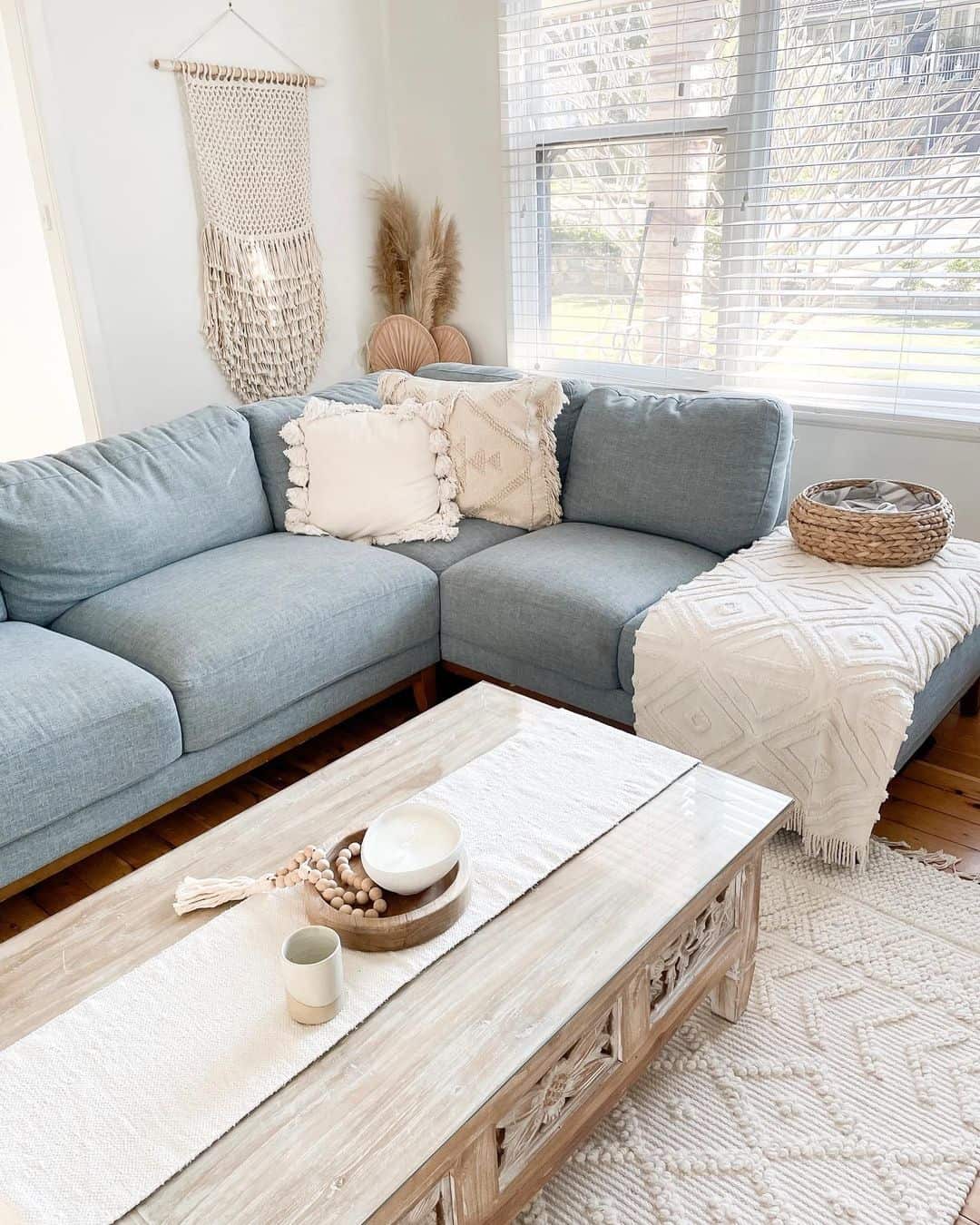 Macrame Wall Hanging Adds Boho Texture Above Blue Sofa