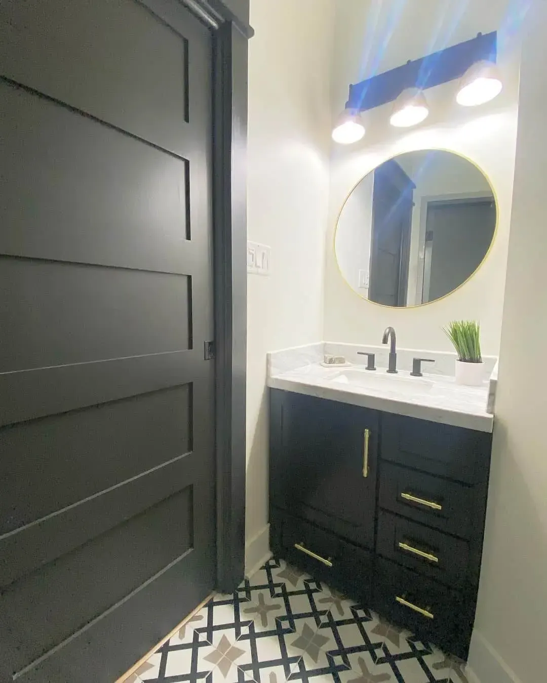 Black Vanity with Brass Hardware and Patterned Floor