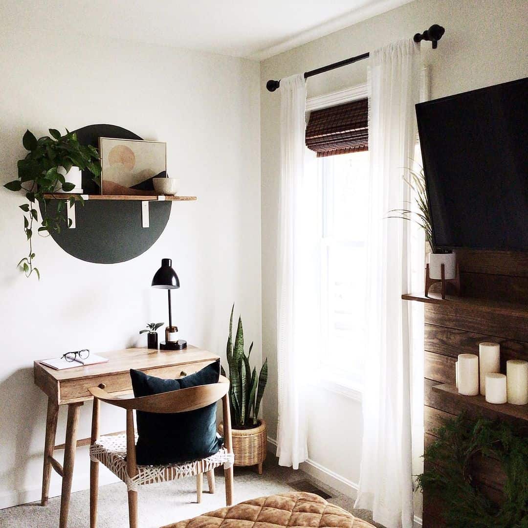 Floating Shelf With Dark Circle Art Holds Trailing Greenery