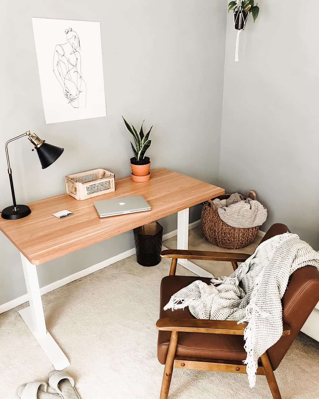 Minimalist Art and Greenery Soften a Wooden Desk