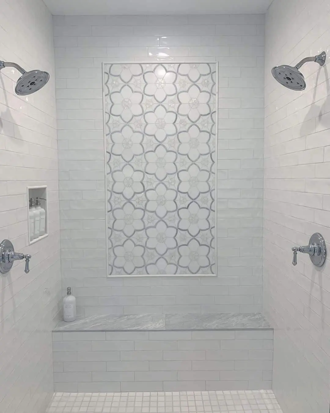 Floral Mosaic Inlay Adds Patterned Depth to White Shower Walls