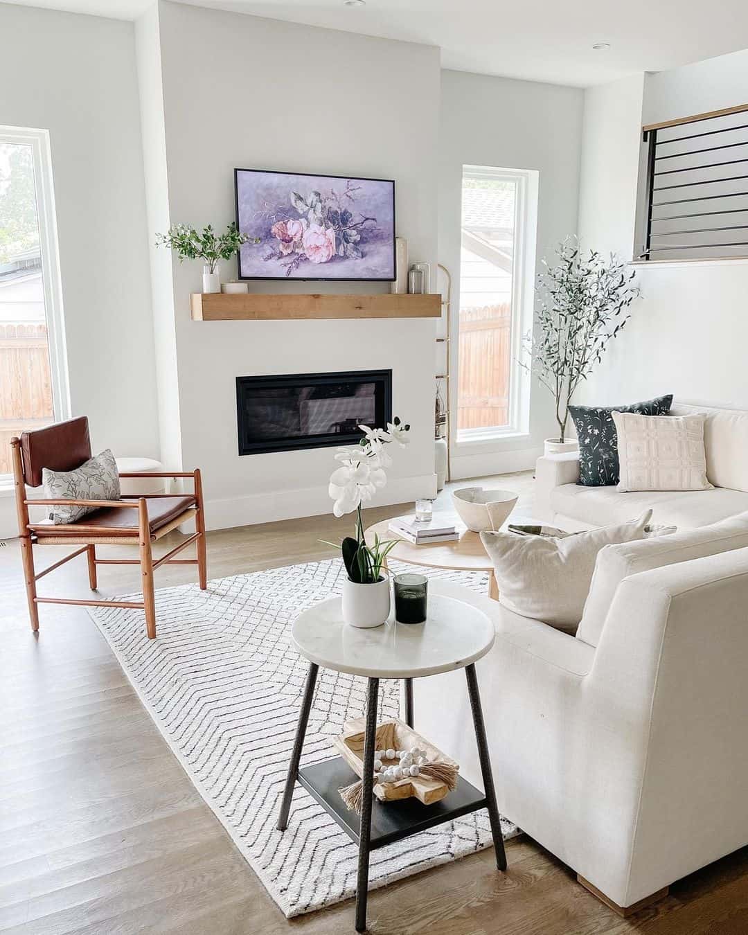 Wood Mantel Frames Floral Art Above a Modern Fireplace