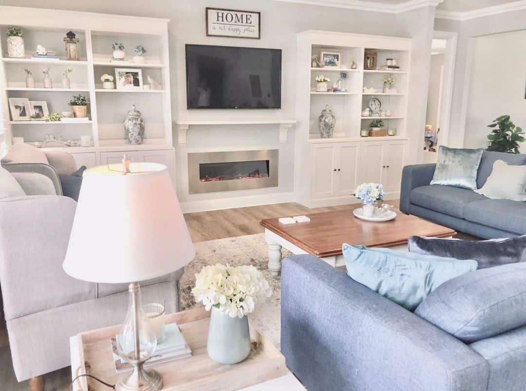 Built-in White Shelving Frames TV and Fireplace