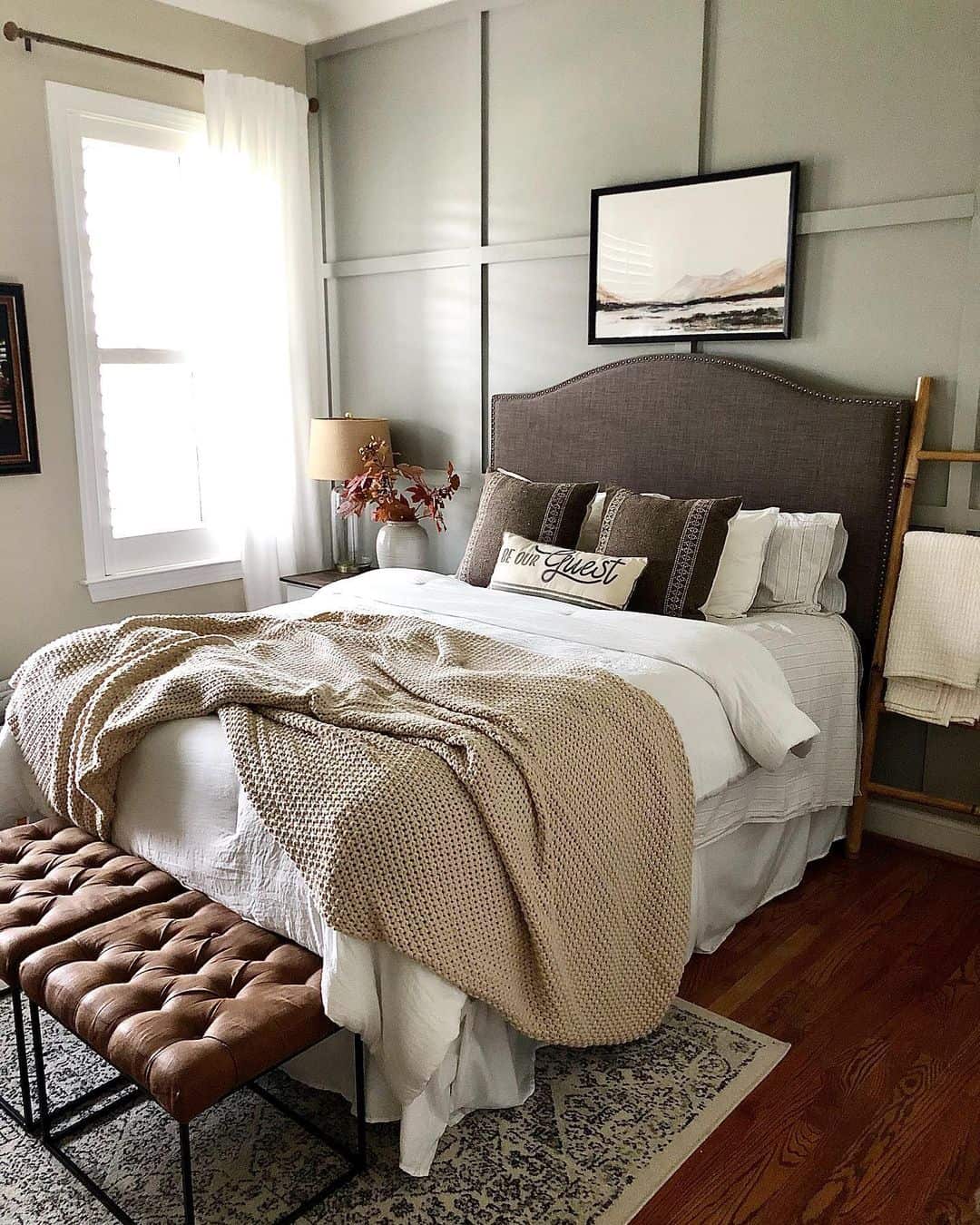 Dark Headboard Frames a Serene Landscape Painting