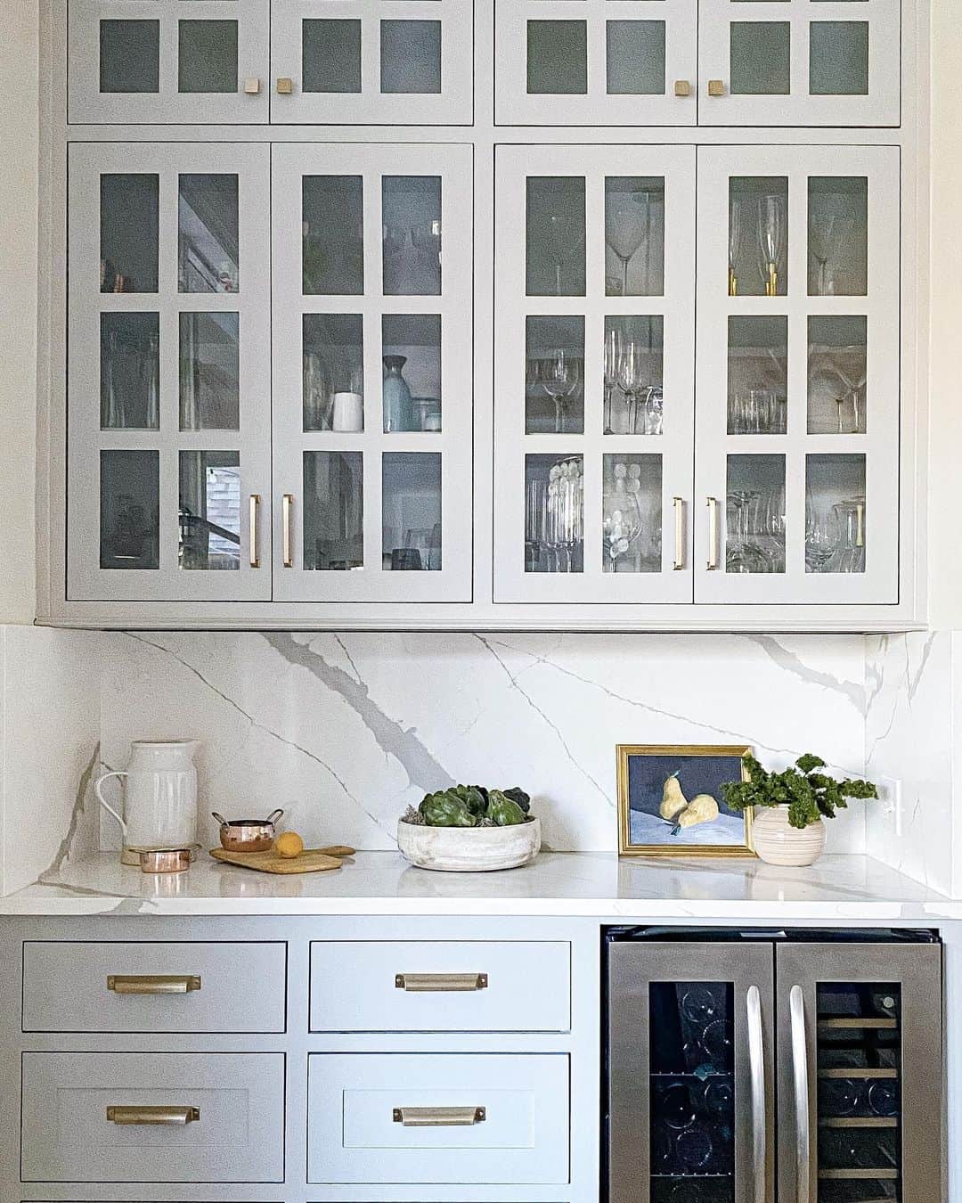 Showcase Delicate Glassware in Light Gray Cabinets with Divided Panes