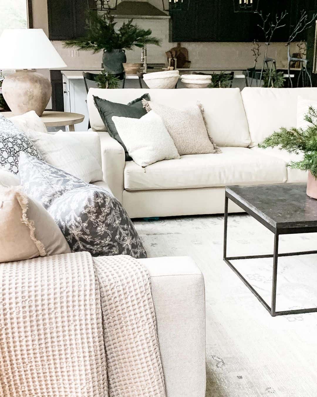 Layer Dark Pillows for Depth on a Cream Sofa