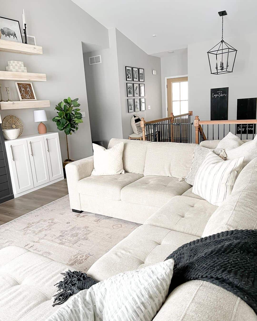 Gallery Wall Above Stairs Adds Vertical Interest