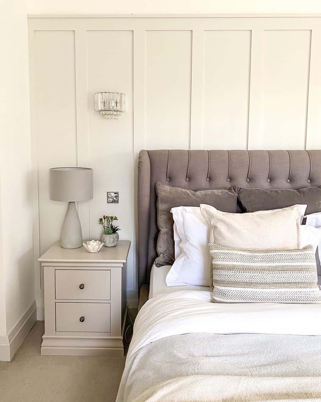 Paneled Wall Accent Frames a Crystal Sconce