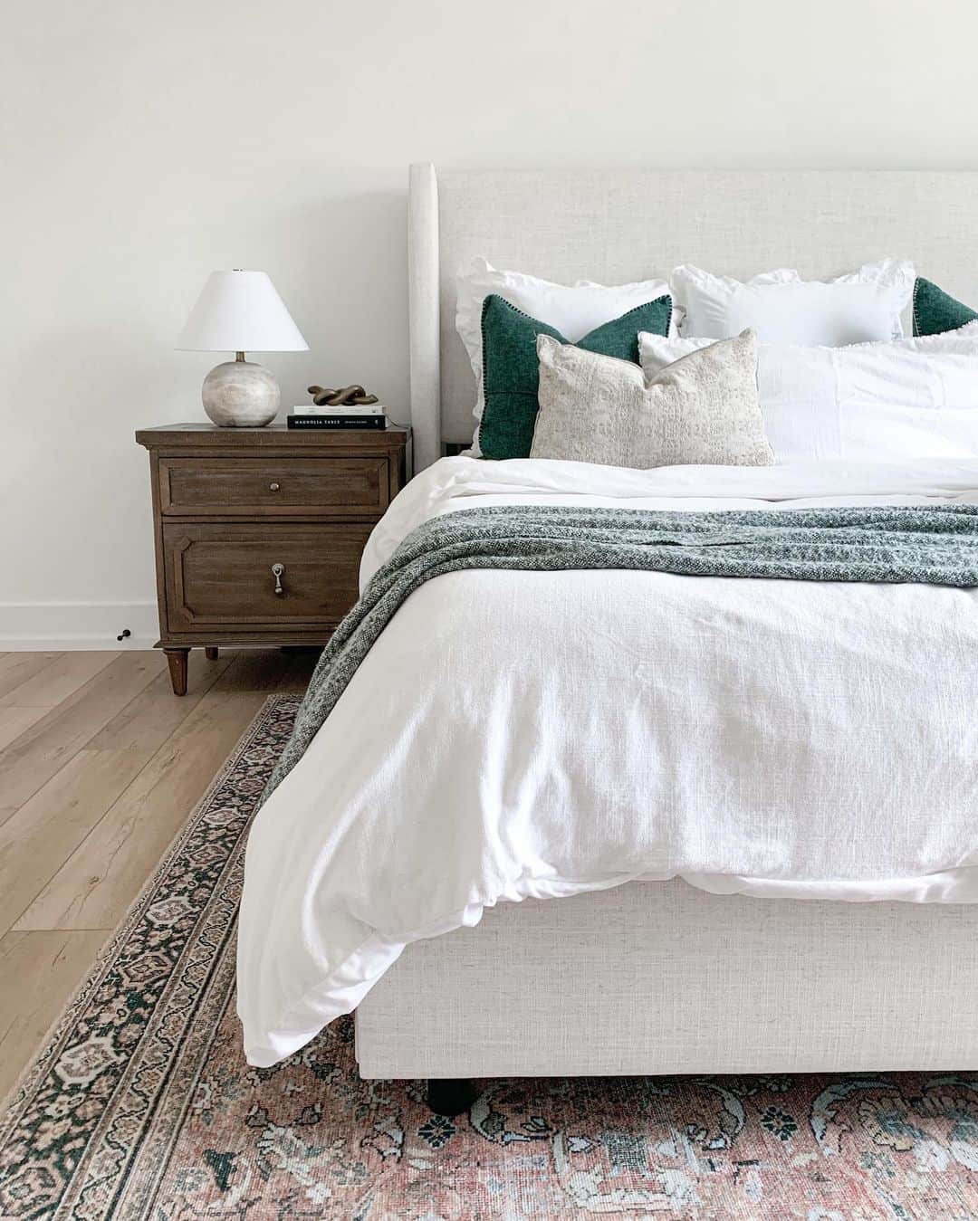 Textured Nightstand Adds Warmth to a Grey and White Bed