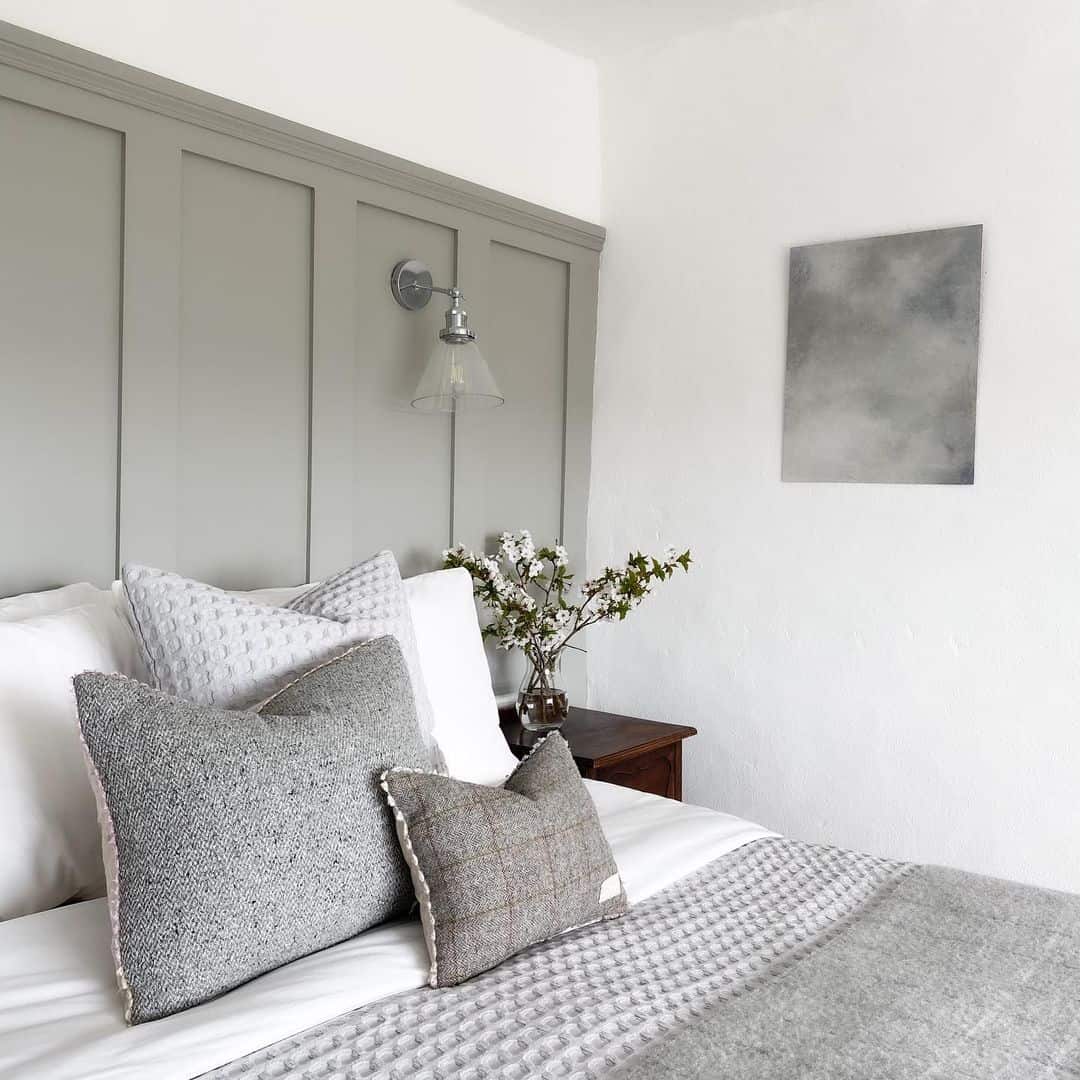 Grey Panel Detail Frames a Modern Wall Sconce