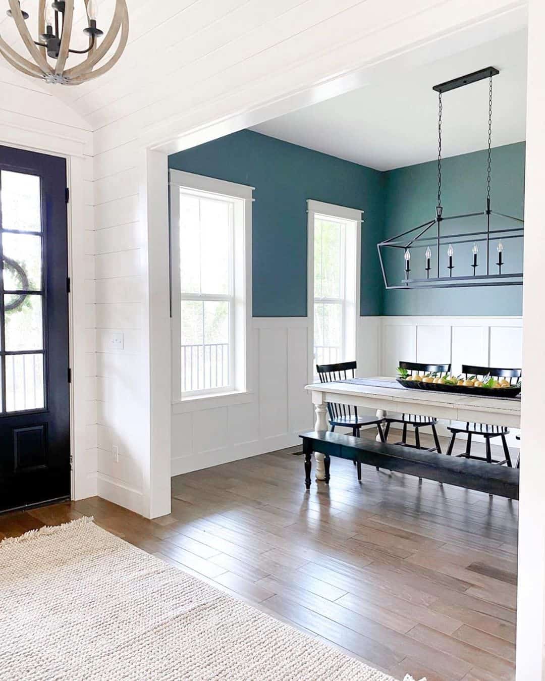 Deep Teal Walls Create a Dramatic Backdrop Above Wainscoting