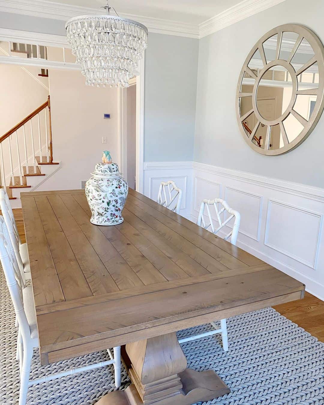 Round Sunburst Mirror Adds Architectural Interest Above Wainscoting