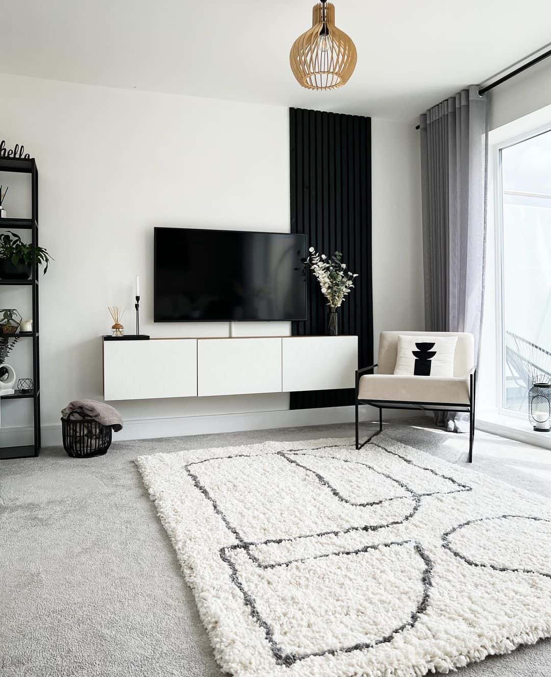 Floating White Console Paired with Black Wood Slats Behind TV