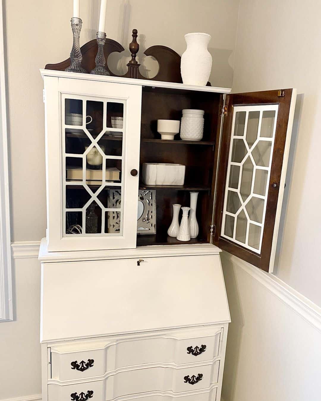 White Secretary Desk with Glass-Paned Cabinet Displays White Vases