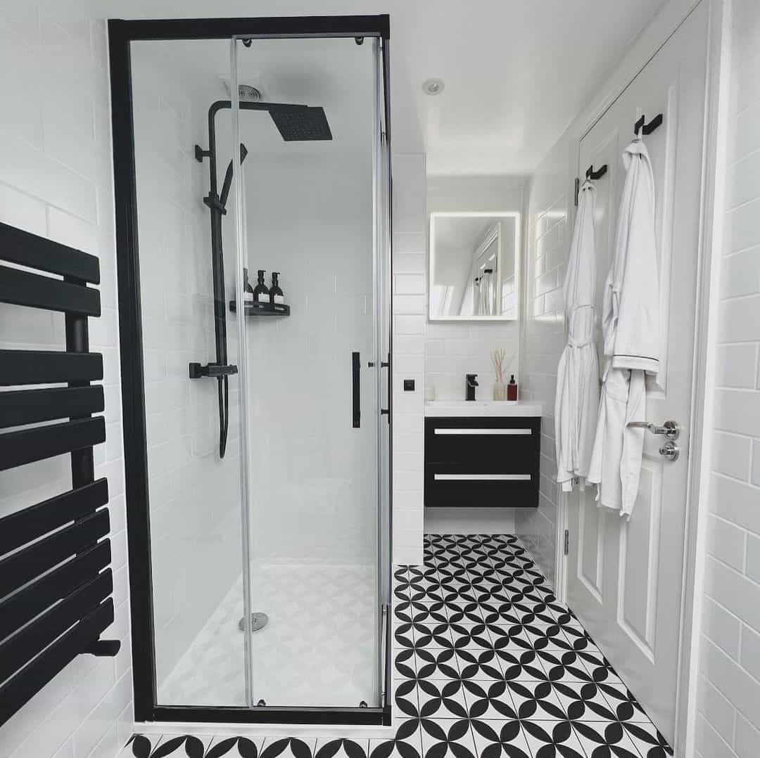 Bold Geometric Floor Tiles Anchor the Black and White Bathroom