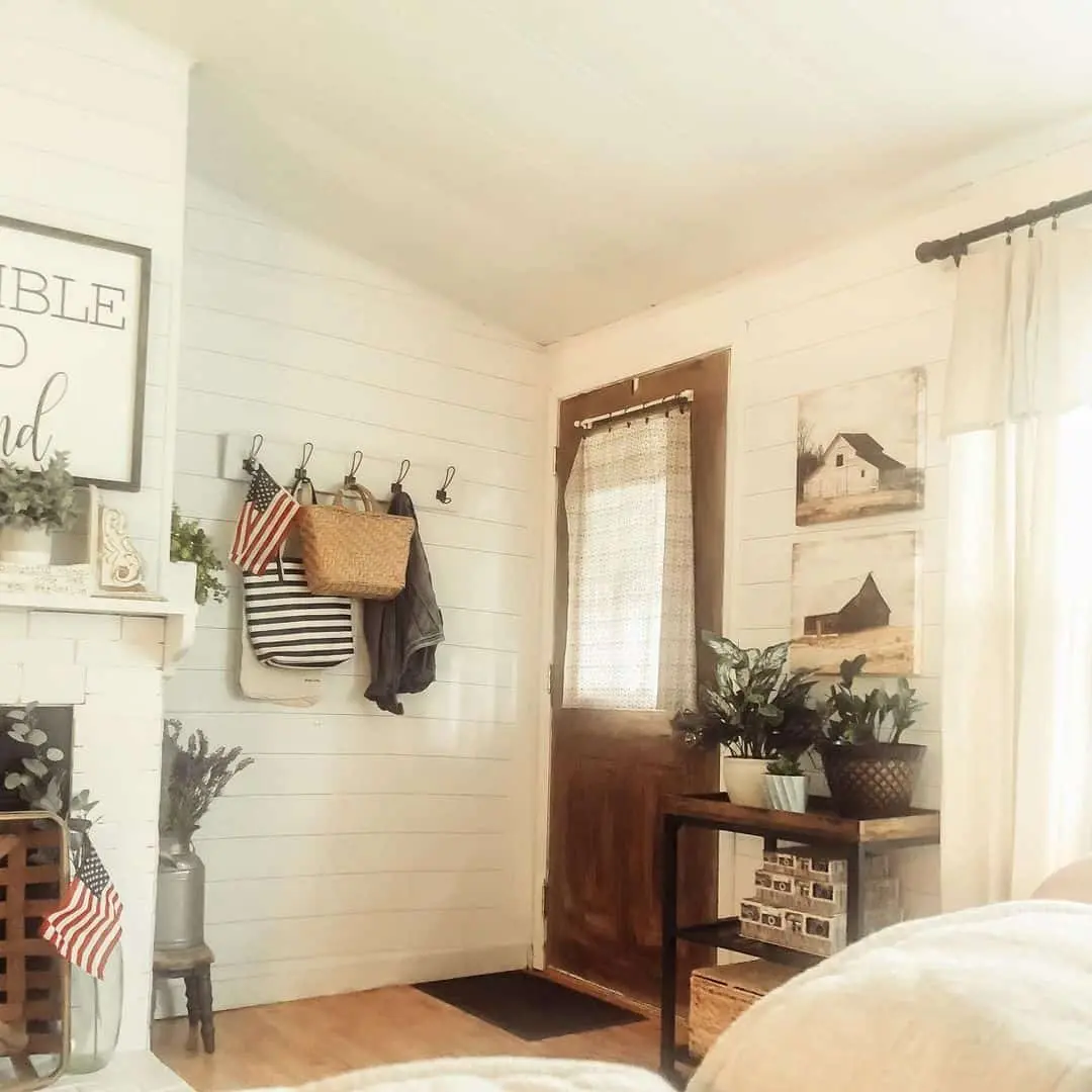 Stack Rustic Barn Paintings Above a Small Entry Table