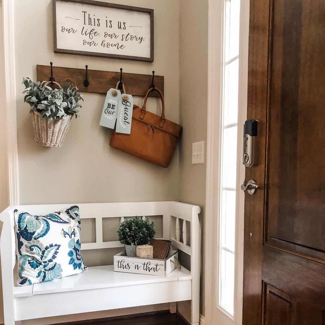Wooden Coat Rack Holds A Leather Tote and a Basket of Greenery